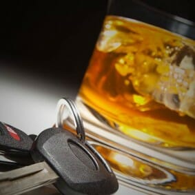 Glass of Bourbon next to car keys | Lexington KY DUI Attorney